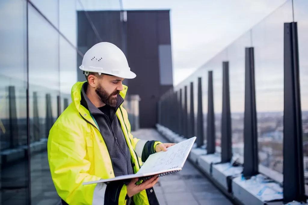 man-engineer-standing-on-construction-site-holdin-2022-02-02-04-50-37-utcwebp23